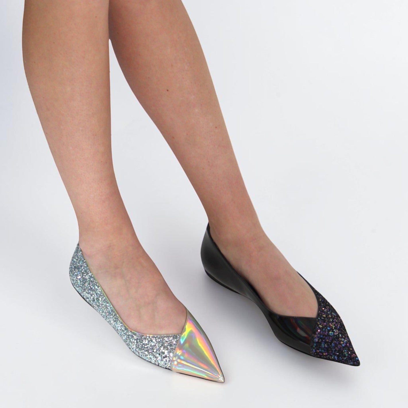 V A L B L V pointed toe ballerina flats featuring asymmetrical silver glitter and stardust patent leather design.