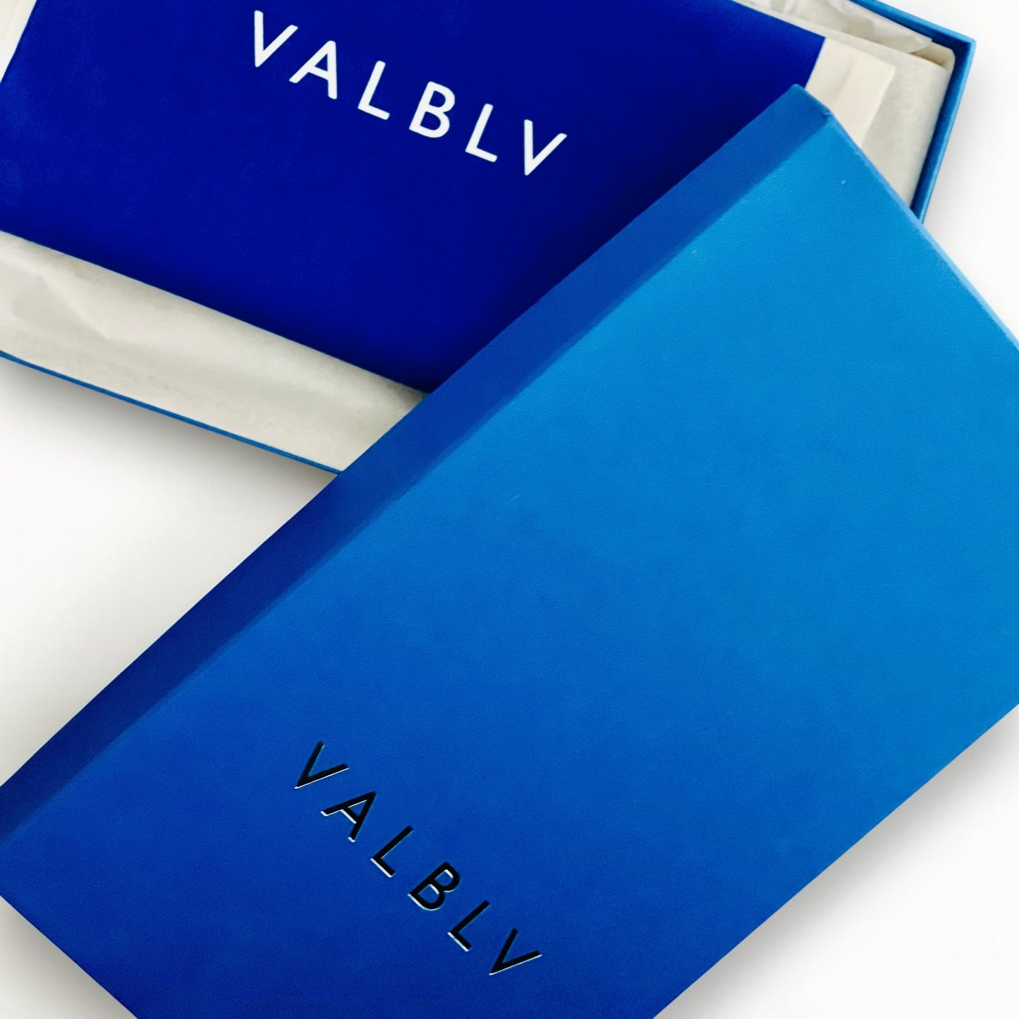 V A L B L V branded blue shoe box and lid featuring minimalist logo design for luxury Italian ballerina flats