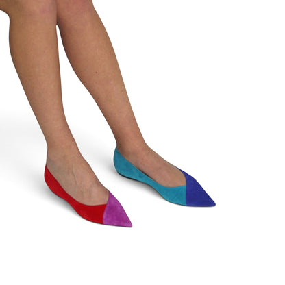 V A L B L V pointed toe flat ballerina shoes in mismatched red, purple, light blue, and dark blue suede on model