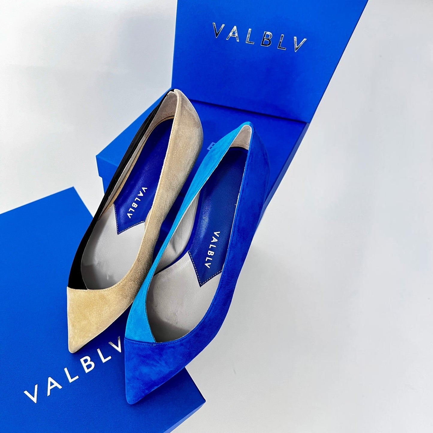 V A L B L V pointed toe ballerina flats in contrasting coal and sand suede with blue accents on V A L B L V boxes.